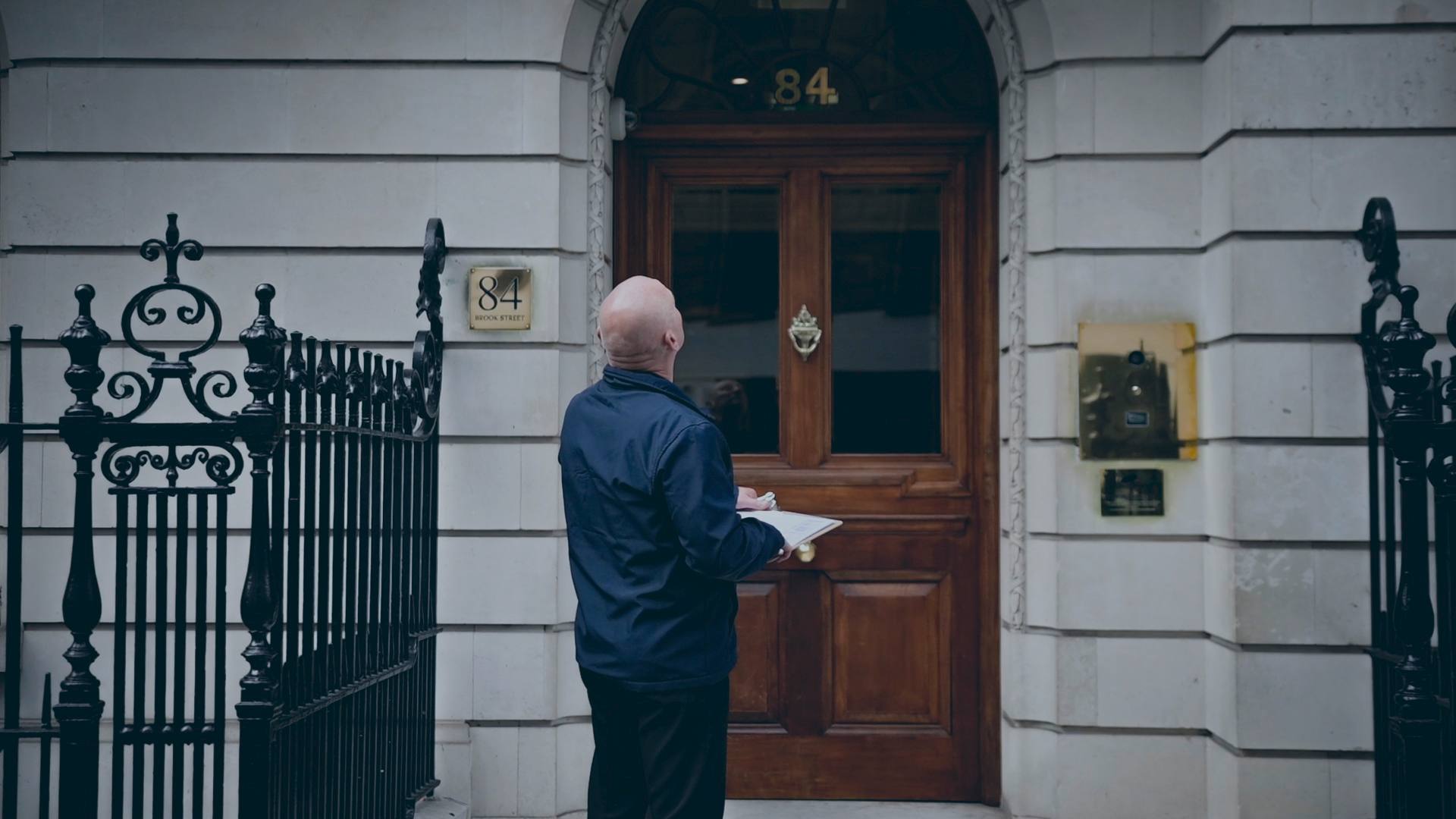 A uniformed officer checking a door on patrol